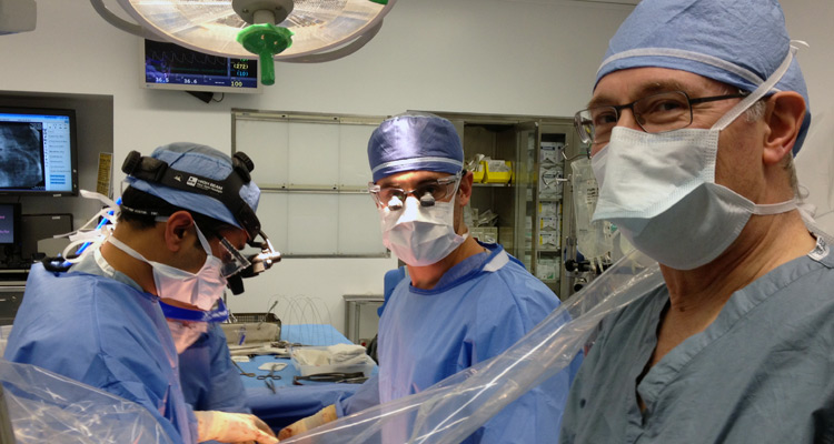 Image of Dr. Aaron Weiss, Dr. Amit Pawale, and Dr. Paul Stelzer in operating room